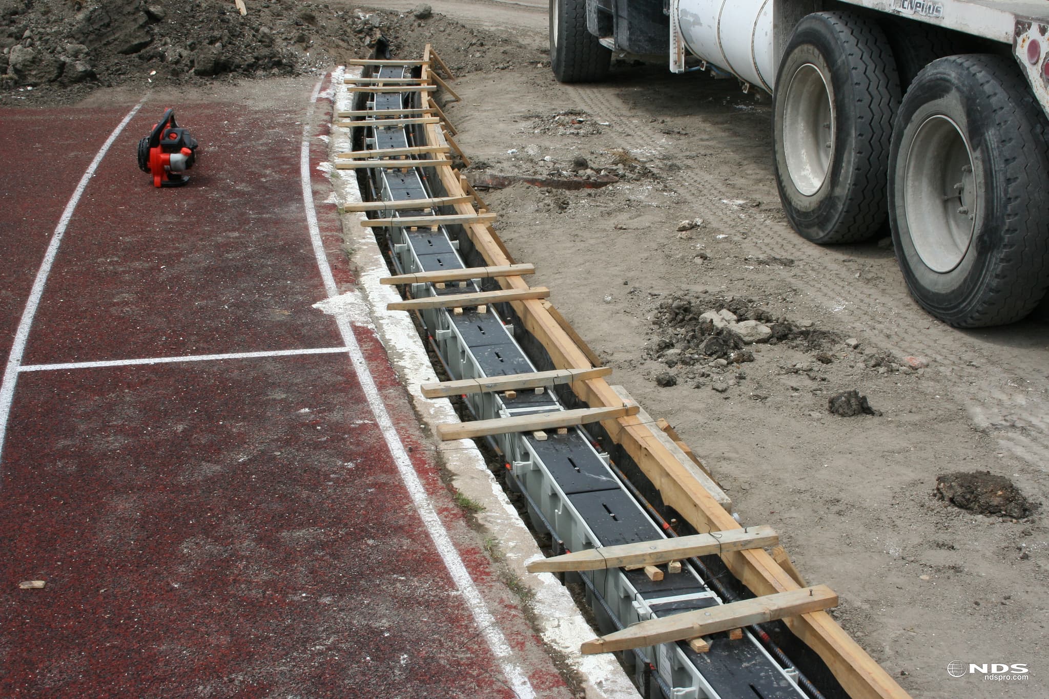 NDS Dura Slope Channel Drain installation in progress showing pre-sloped HDPE channel system