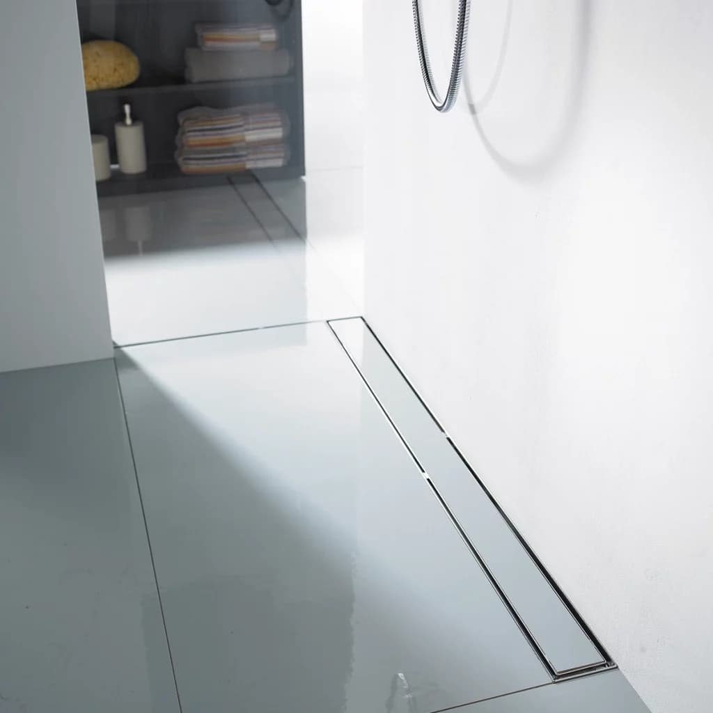 ACO ShowerDrain stainless steel linear shower channel installed flush in a tiled wet-room bathroom floor